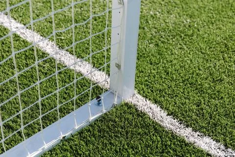 Soccer net background, view from behind the goal with blurred field pitch Stockfoto's