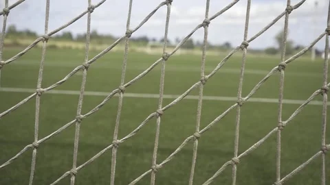 Soccer net close-up showing empty field on sunnyan great day Stock Footage 307584404
