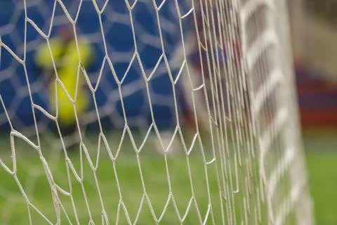 Soccer net in the foreground Stock Photos