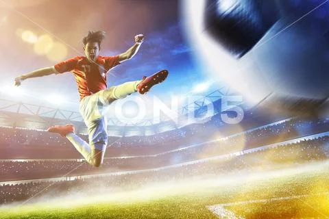 Soccer player in action on night stadium background Stock Photos