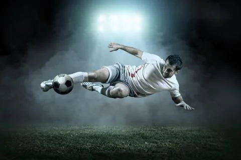 Soccer player with ball in action outdoors Stock Photos