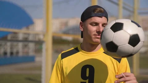 Soccer Player in A Baseball Cap Throwing the Ball From Hand to Hand Stock Footage 152080241