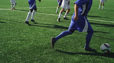 A soccer player dribbles down the field during a game Stock Footage 56137510