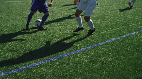A soccer player dribbles down the field as an opponent defends him closely Stock Footage 56189872