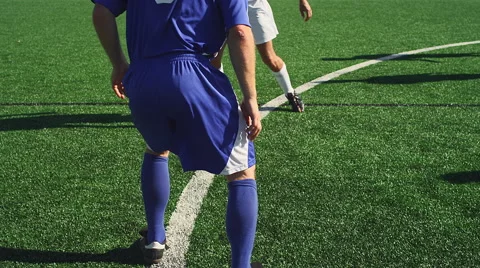 A soccer player dribbles down the field as an opponent defends him Stock Footage 56192904