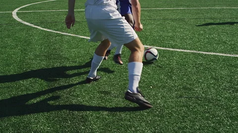A soccer player dribbles down the field as an opponent defends him Stock Footage 56194404