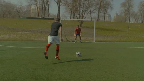 Soccer player going for penalty kick during match Stock Footage