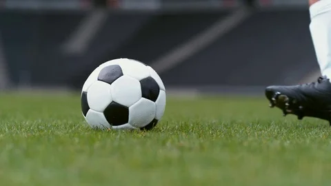 Soccer player kicking ball on field slow motion Stock Footage