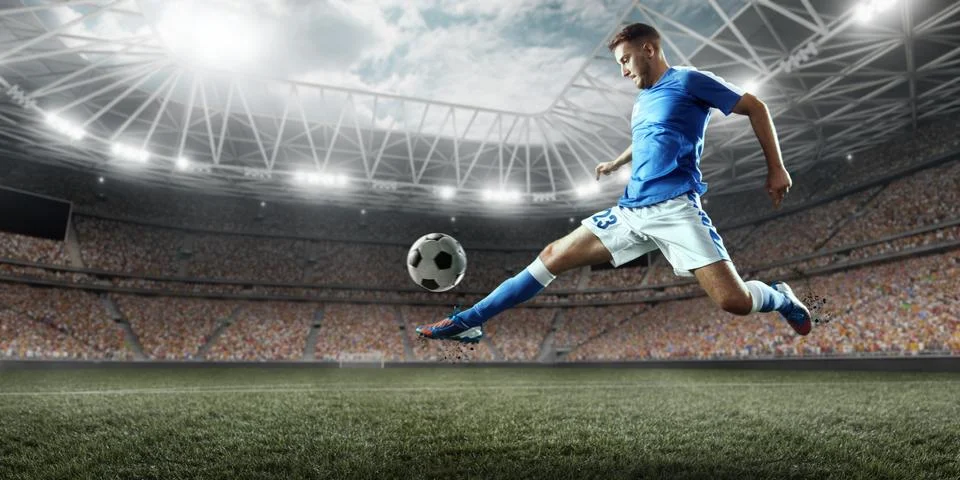Soccer player performs an action play on a professional stadium Stock Photos