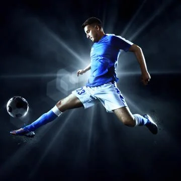 Soccer player performs an action play on a professional stadium Stock Photos