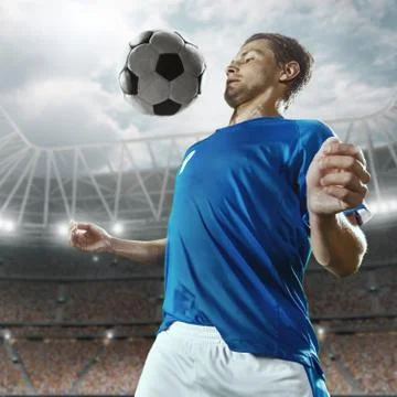 Soccer player performs an action play on a professional stadium Stock Photos