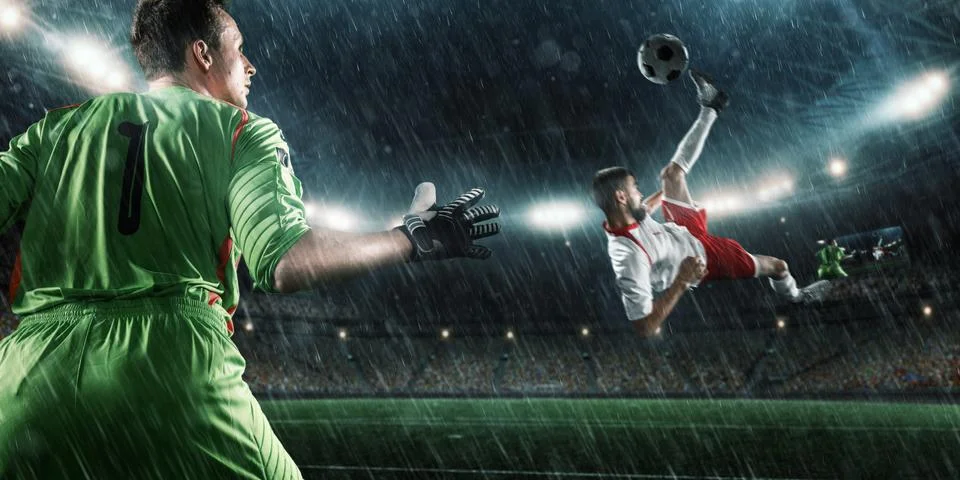 Soccer player performs an action play on a professional stadium Stock Photos