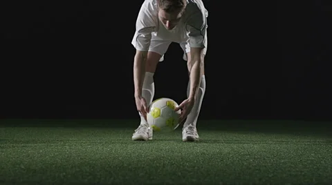 A soccer player placing a ball and then running up and kicking it Video stock 34008065