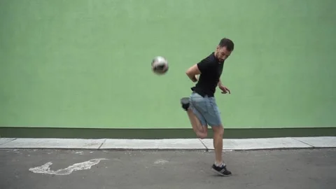 Soccer player plays with the ball. Doing football tricks. Outdoor. Slow motion Stock Footage 90849580