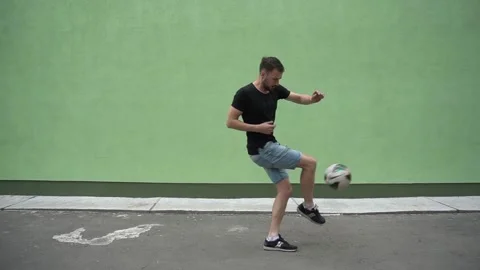Soccer player plays with the ball. Doing football tricks. Outdoor. Slow motion Stock Footage 90850768