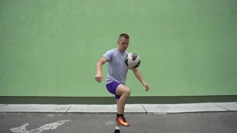 Soccer player plays with the ball. Doing football tricks. Outdoor. Slow motion Stock Footage 90853061