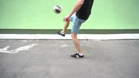 Soccer player plays with the ball. Doing football tricks. Outdoor. Slow motion Stock Footage 90855458