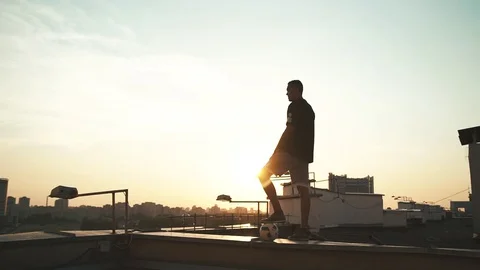 Soccer player on the roof Stockbeeldmateriaal 129466853