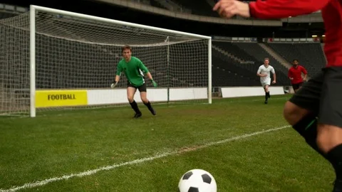Soccer player scores goal in slow motion Stock Footage