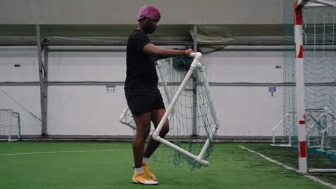 Soccer Player Setting Up Small Goal for Shooting Practice Vidéo 306825599
