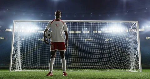 Soccer player is standing in front of the goal on the empty soccer stadium Stock Footage 126523242