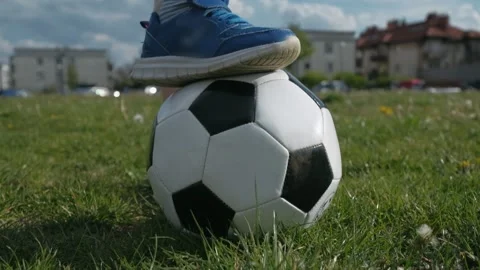 Soccer player standing with one foot on the ball on soccer field. Tilt up Stock Footage 131095660
