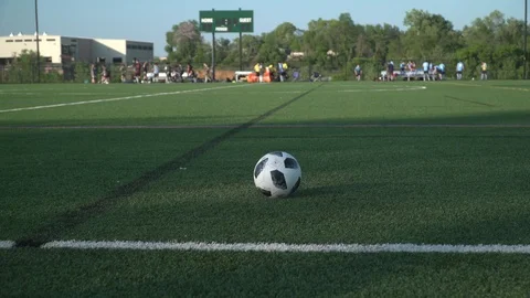 Soccer Players Chasing Down a Ball in Slow motion while camera pans left Video stock 92060281