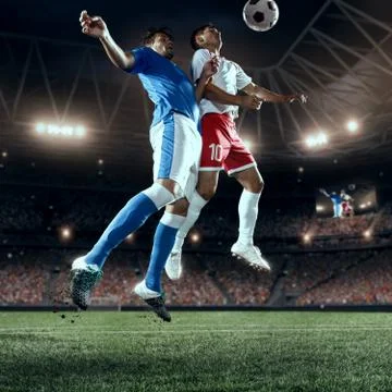 Soccer players performs an action play on a professional stadium Stock Photos