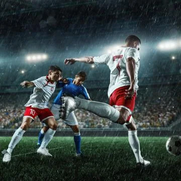 Soccer players performs an action play on a professional stadium Stock Photos