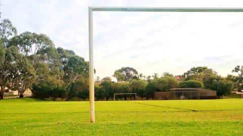 Soccer posts and an empty soccer field on a cloudy day Stock Photos