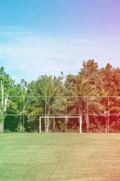 Soccer posts in park, field is partially covered in the shadow. Trees in the  Stock Photos