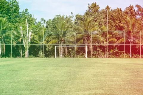 Soccer posts in park, field is partially covered in the shadow. Trees in the  Stock Photos