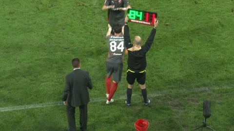Soccer substitution on match game.Football players, referee with digital board Stock Footage
