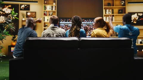 Soccer supporters at home react angrily to referee call on TV Stock Footage 338176052