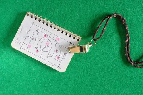 Soccer tactics scribble on notepad and whistle of soccer referee or trainer.. Stock Photos