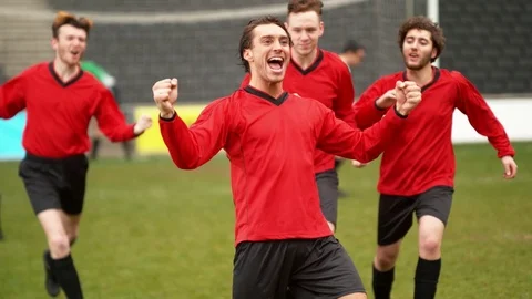 Soccer team celebrating football match win as whistle blows Stock Footage