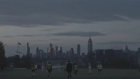 Soccer Team Practicing With NYC Skyline In Background At Sunset - 4K - RAW Stock Footage 238794927