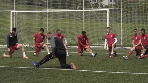 Soccer team warming and stretching body with fitness trainer on training court Stock Footage 89602518