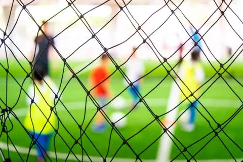 Soccer training net blur on training ground with children Stock Photos