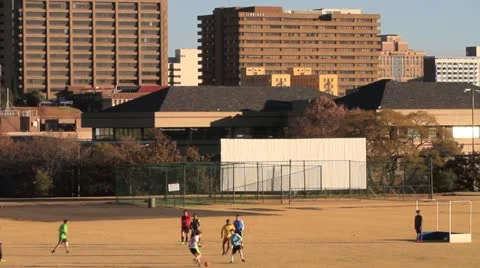 Soccer under Joburg Buildings MS GFHD Stock Footage