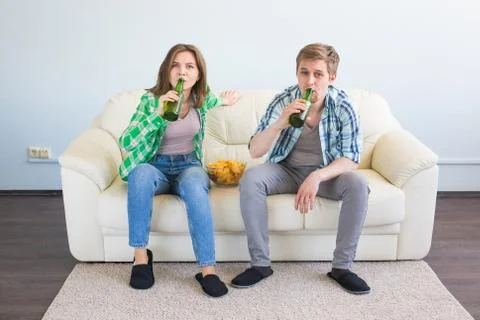 Soccer world cup concept - Modern couple looking excited and happy watching Stock Photos