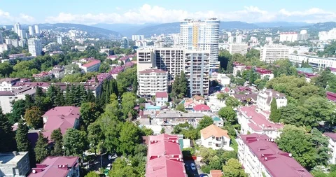 Sochi city on a background of mountains. Quadcopter flight over the city center Stock Footage