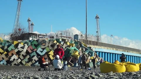 Sochi Russian - 16 Jan 2022: A married couple with a child and people walking Stock Footage 169809656