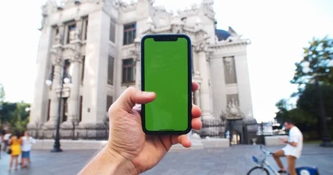 Sociable man using mobile phone chromekey digital greenscreen against gorgeous Stock Footage 115672524