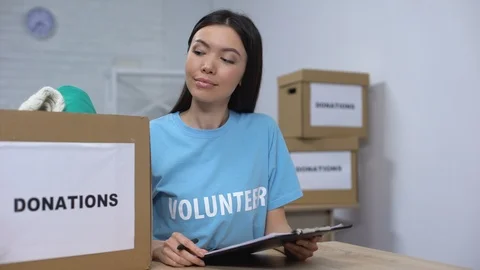 Social center worker preparing donation box smiling camera, charity organization Stock Footage 113390174
