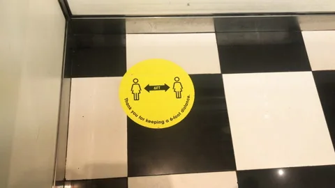 Social distance sign in elevator  2 m or 6 ft distancing for  Stock Footage 142448099