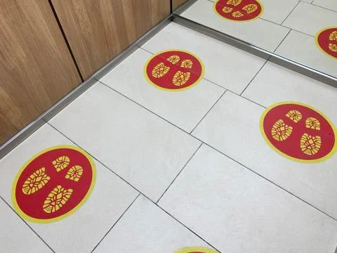 Social distance signs on the floor in the elevator Stock Photos