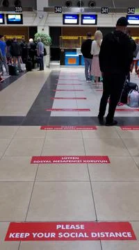 Social distance warning and queue to check in airport Stock Photos