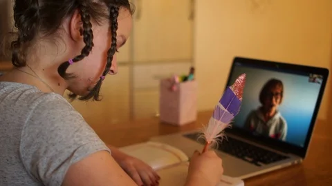 Social distancing concept, remote learning. Little girl using a computer laptop Stock Footage 128818574