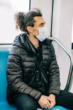 Social distancing to crowd while commuting in the Rome underground. Man wearing Stock Photos